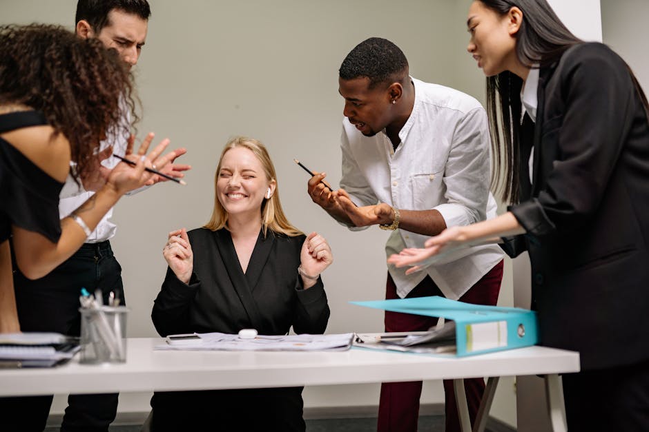 A lively and diverse team collaborates in a modern office setting. Vibrant discussion and teamwork.
