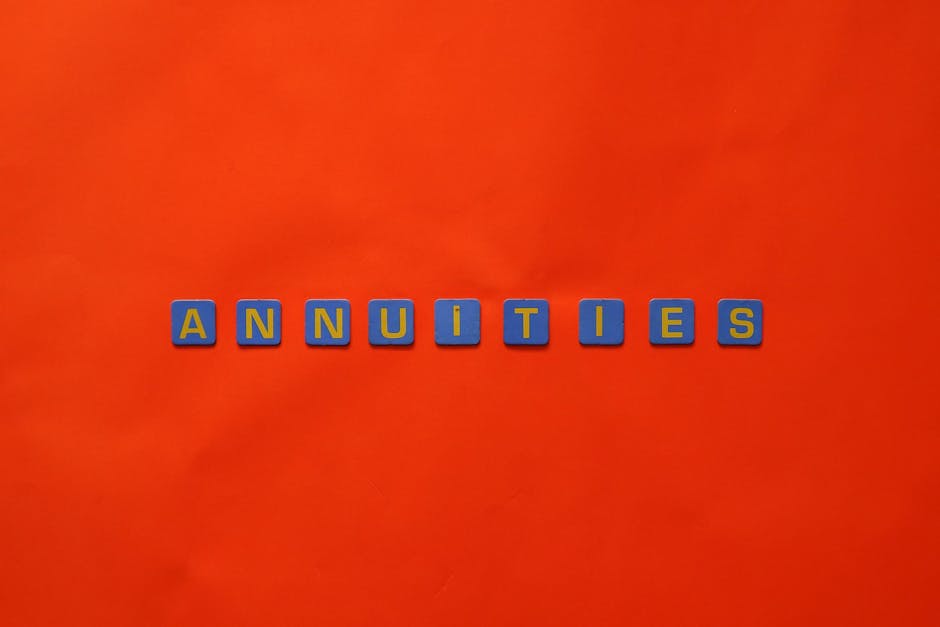 Conceptual image of the word 'Annuities' spelled with tiles on a vibrant red background.